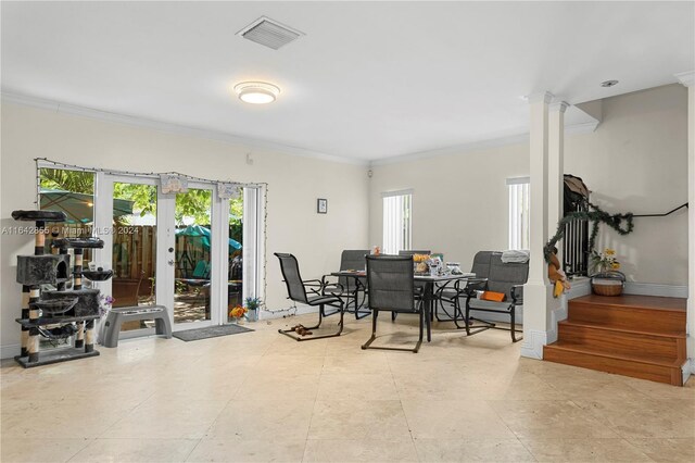 dining space with ornate columns, french doors, crown molding, and light tile patterned floors