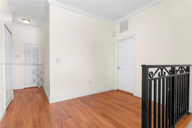 unfurnished room with crown molding and hardwood / wood-style floors