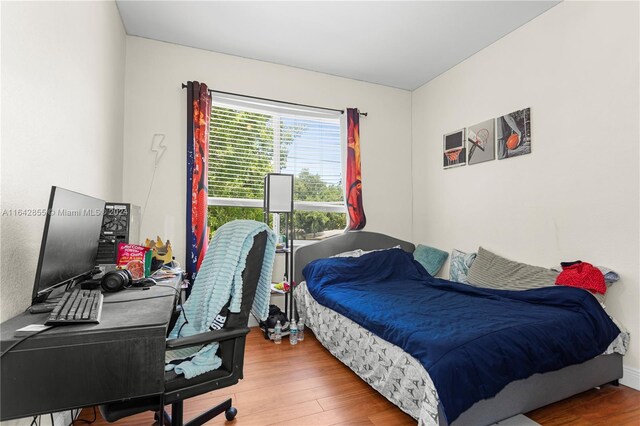 bedroom with hardwood / wood-style flooring