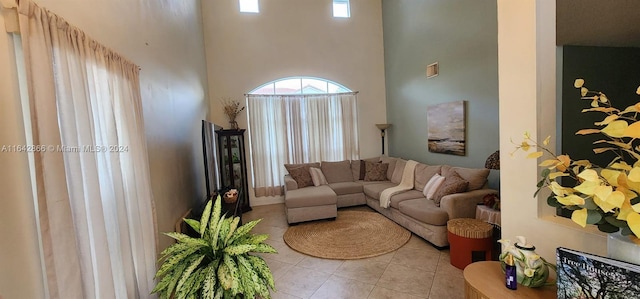 tiled living room featuring a high ceiling