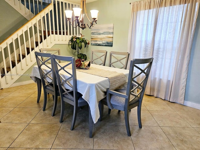 dining area featuring an inviting chandelier and light tile patterned flooring