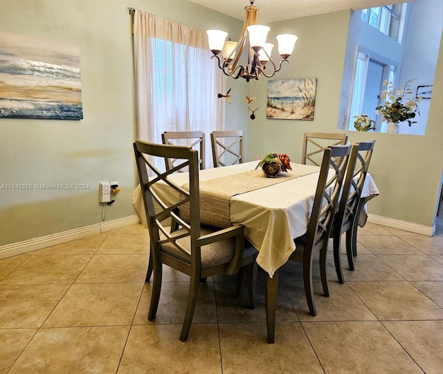 dining space with light tile patterned floors, a wealth of natural light, and an inviting chandelier