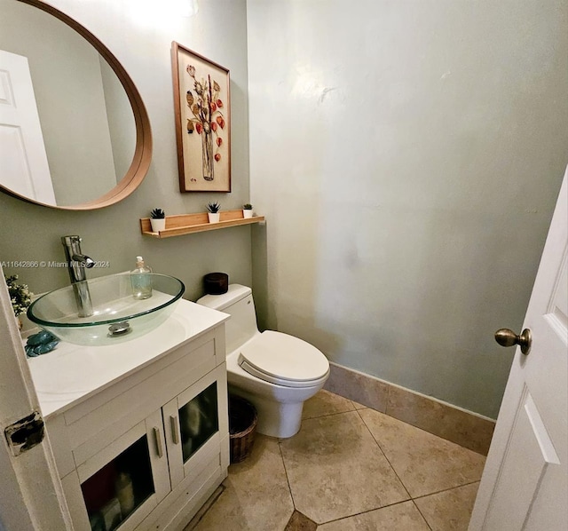 bathroom with vanity, toilet, and tile patterned floors