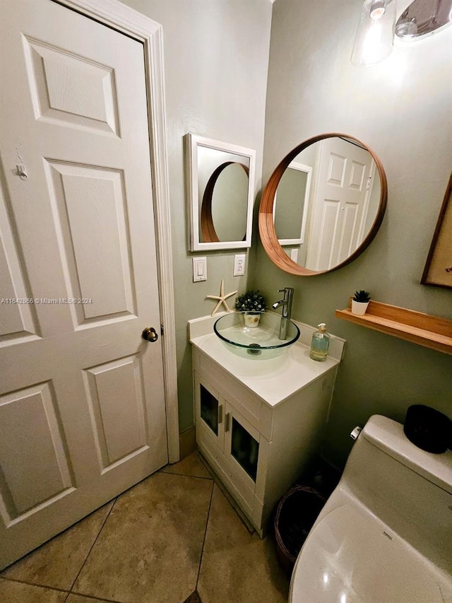 bathroom with vanity, toilet, and tile patterned floors