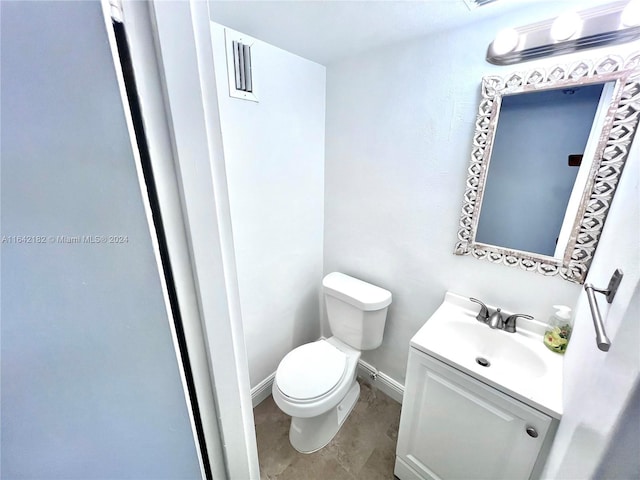 bathroom featuring tile patterned flooring, vanity, and toilet