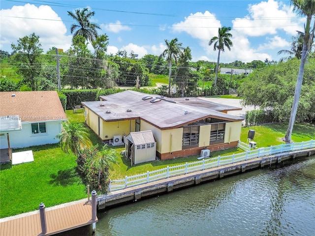 back of property featuring a yard and a water view