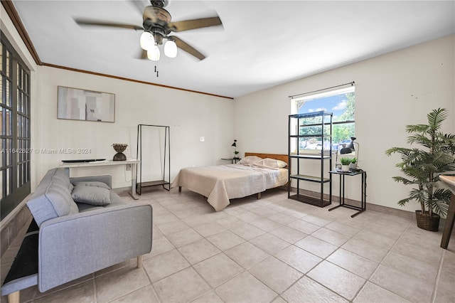 tiled bedroom with ceiling fan and ornamental molding