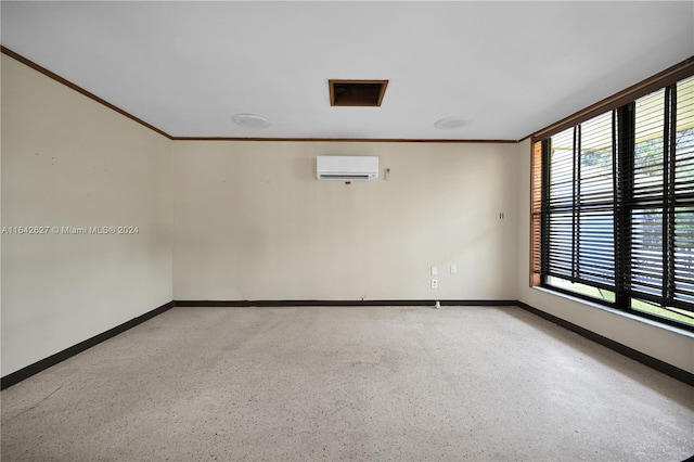 empty room featuring crown molding and an AC wall unit