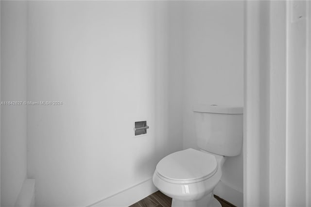 bathroom featuring hardwood / wood-style flooring and toilet