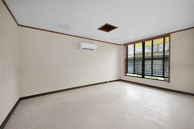 spare room with crown molding and a wall unit AC