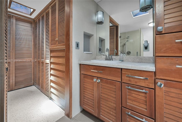 bathroom featuring a skylight and vanity