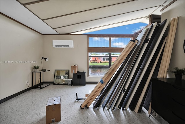 interior space featuring a wall unit AC and lofted ceiling