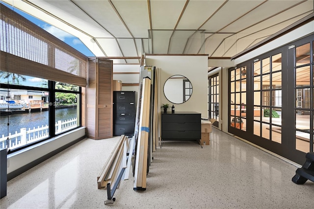 interior space with french doors and a water view