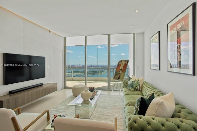 living room featuring floor to ceiling windows and a water view