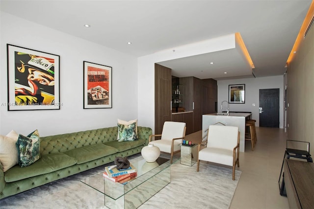 living room with light tile patterned floors and sink