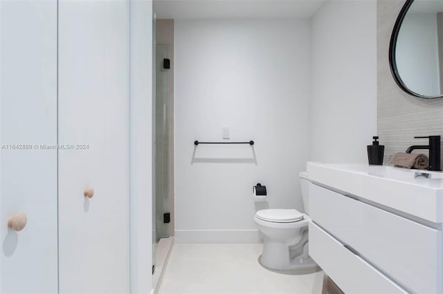 bathroom featuring tile patterned floors, toilet, an enclosed shower, and vanity