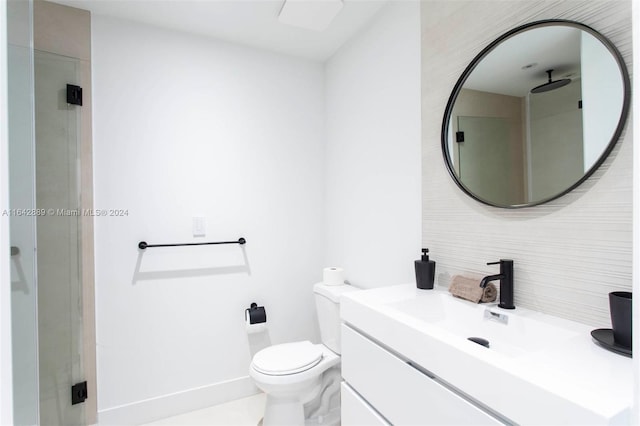 bathroom with tile patterned floors, a shower with door, vanity, and toilet