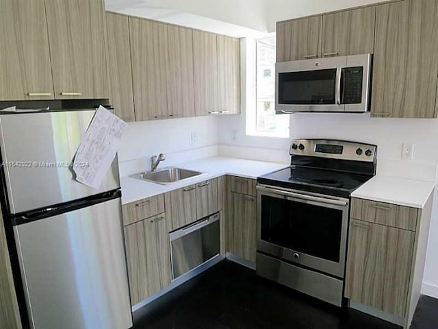 551 Michigan Ave Unit 125, Miami Beach, FL 33139 - kitchen with a sink, stainless steel appliances, light brown cabinets, modern cabinets, and light countertops