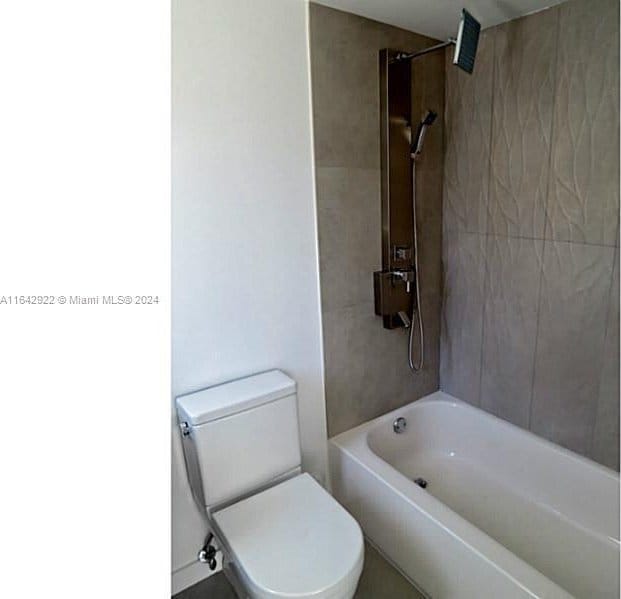 551 Michigan Ave Unit 125, Miami Beach, FL 33139 - bathroom featuring toilet and shower / bathtub combination