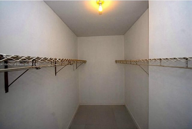 walk in closet featuring tile patterned flooring