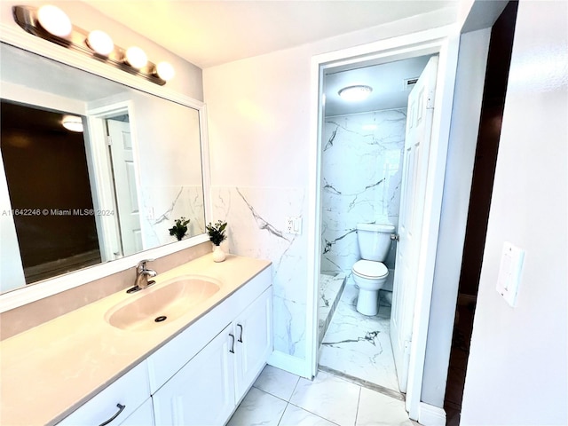 bathroom featuring tile patterned floors, tile walls, vanity, and toilet