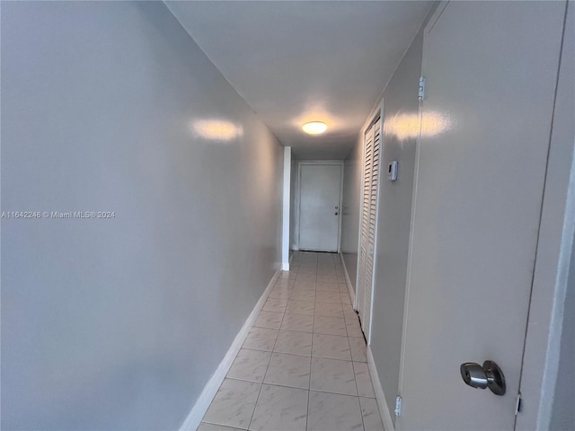 hall featuring light tile patterned floors