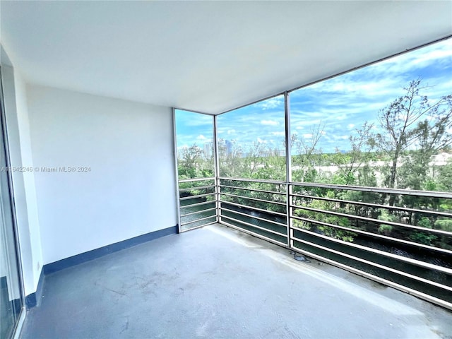 unfurnished room with concrete floors