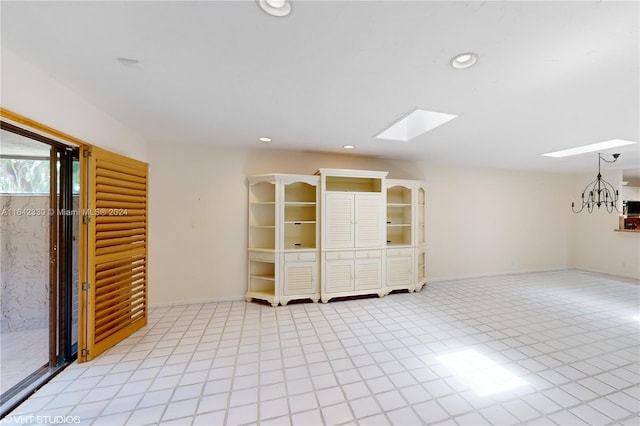 spare room featuring a skylight, baseboards, and recessed lighting