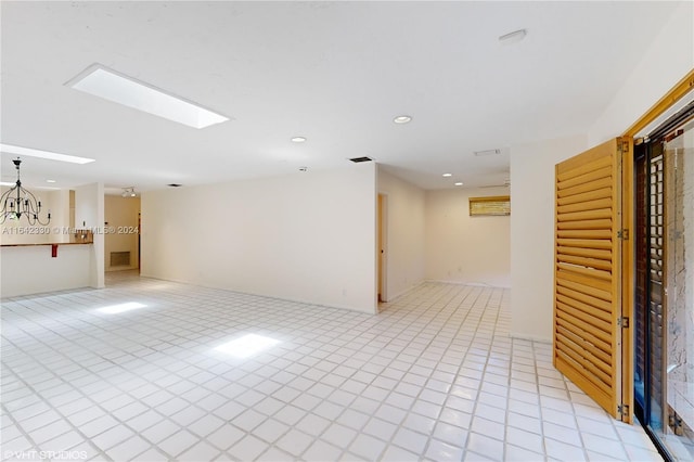 unfurnished room with light tile patterned floors, a skylight, visible vents, and recessed lighting