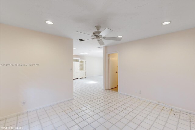 spare room featuring light tile patterned floors and ceiling fan