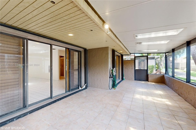 unfurnished sunroom with wooden ceiling