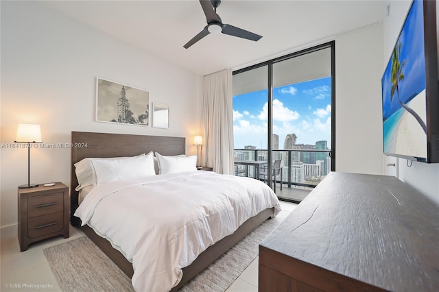 bedroom featuring access to outside, expansive windows, and ceiling fan