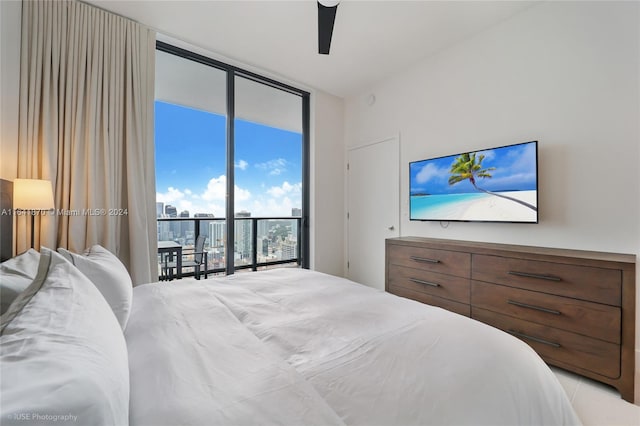 bedroom featuring floor to ceiling windows, ceiling fan, and access to exterior