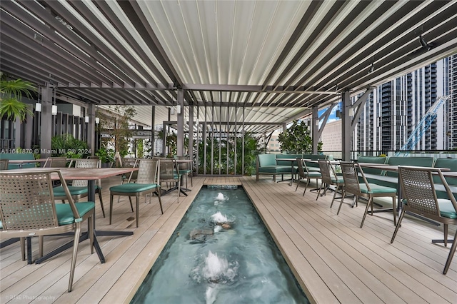 wooden terrace featuring a hot tub