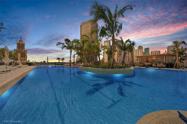 view of pool at dusk