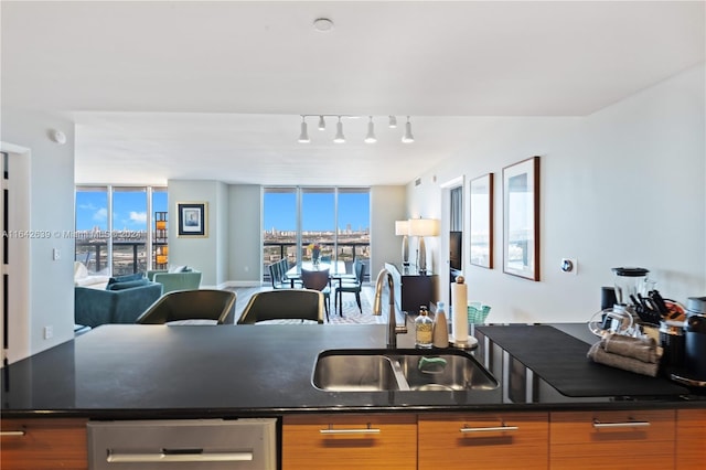 kitchen featuring sink, expansive windows, and hardwood / wood-style flooring