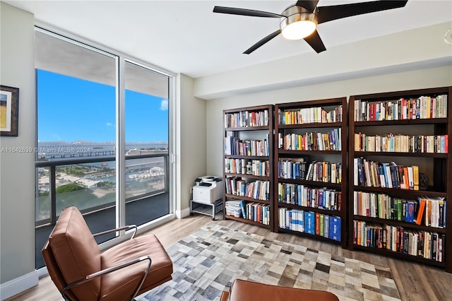 sitting room with light hardwood / wood-style flooring and ceiling fan