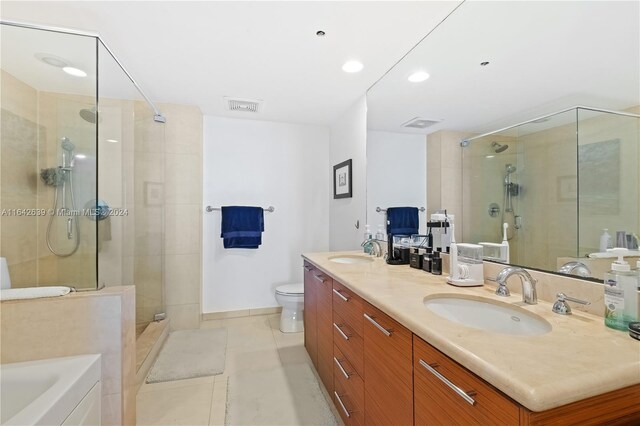 full bathroom with tile patterned flooring, independent shower and bath, toilet, and vanity