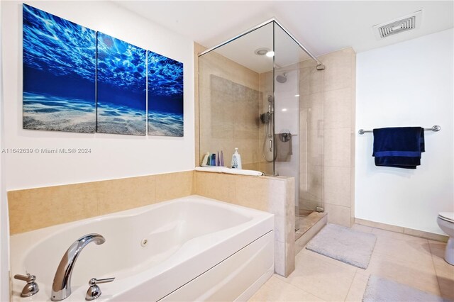 bathroom featuring toilet, independent shower and bath, and tile patterned floors