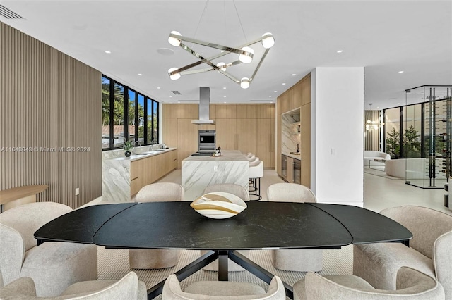 dining area with sink and an inviting chandelier