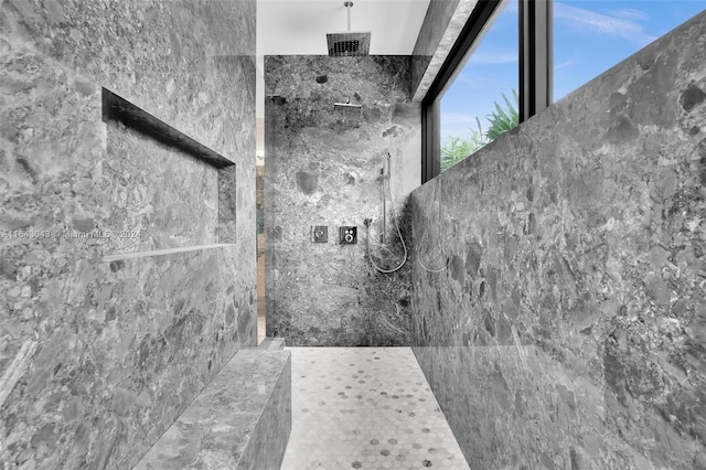 bathroom with tile walls and tiled shower