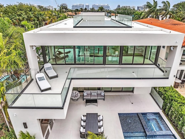 back of house with a patio and an outdoor living space