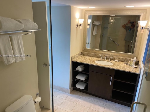 bathroom with tile patterned flooring, vanity, and toilet