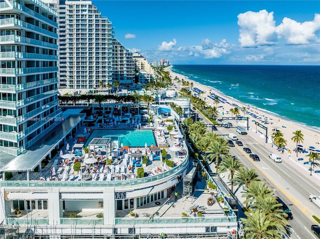 birds eye view of property with a beach view and a water view