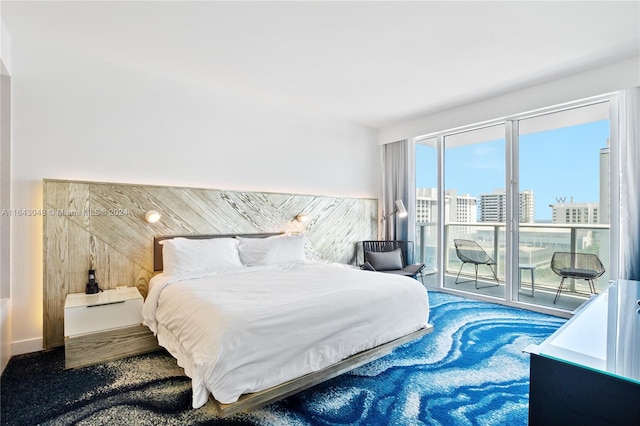 bedroom featuring carpet floors, multiple windows, and access to exterior