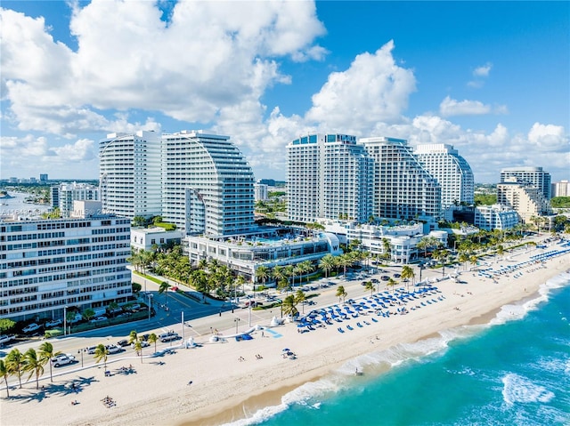 birds eye view of property featuring a beach view and a water view