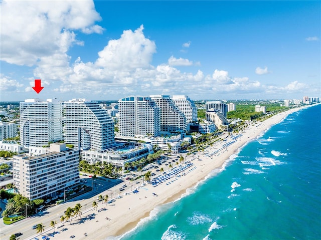 birds eye view of property with a beach view and a water view