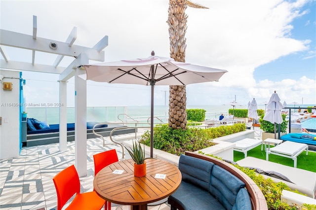 view of patio / terrace with a pergola, an outdoor hangout area, and a water view