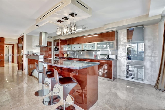19667 Turnberry Way Unit 3E, Aventura, FL 33180 - bar featuring decorative light fixtures, island range hood, light tile patterned flooring, and an inviting chandelier