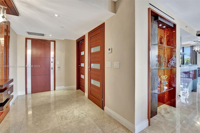 19667 Turnberry Way Unit 3E, Aventura, FL 33180 - corridor with recessed lighting, an inviting chandelier, light tile patterned floors, visible vents, and baseboards